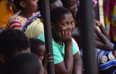 Community member looks on as Magnet Theatre performs